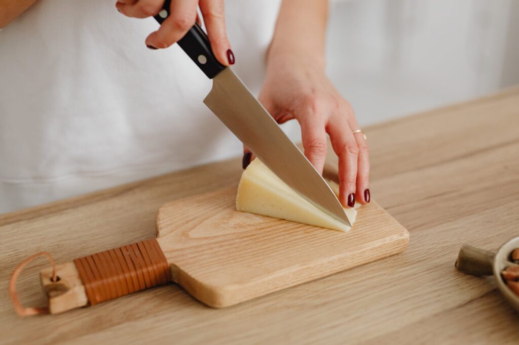 Using knife to cut cheese