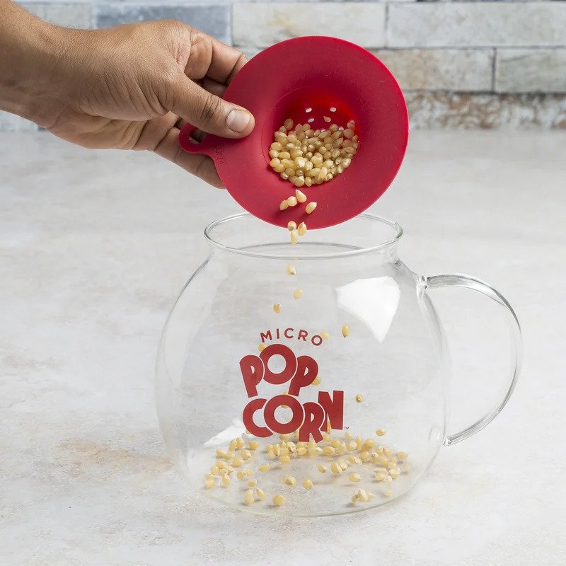 Ecolution Patented Micro-Pop Popcorn Popper adding the corn
