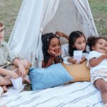 Kids eating popcorn whiles camping