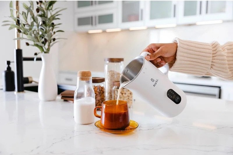 Pouring milk from the NUTR Automatic Nut Milk Maker